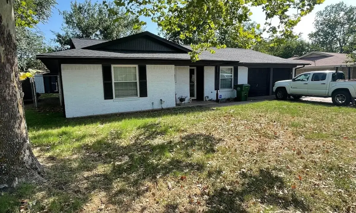 Professional roofing crew working on a residential roof in Manchester